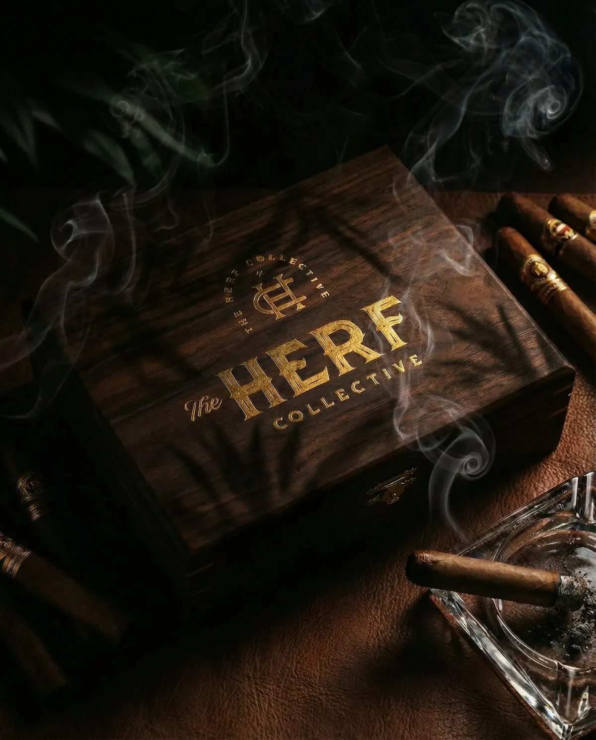 Herf Collective cigar box with a gold mark, cigars and smoke